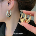 Textured and Polished Oval Hoop Earrings in Gold and Silver view 4