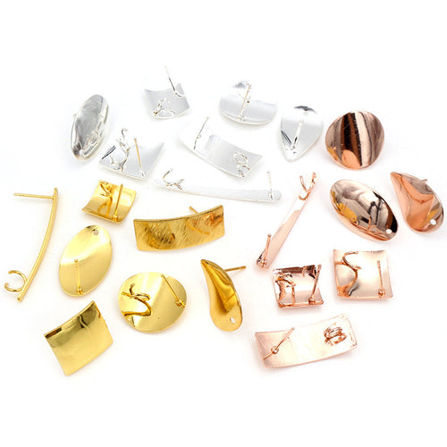 Overview of twenty-one polished geometric earring post designs in gold, silver and rose gold tones on a light background