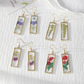 Gold Tone Slim Rectangular Pressed Flower Drop Earrings in Four Designs view 1