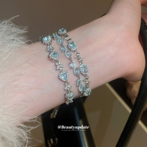 three pale blue crystal bracelets with oval, heart, or mixed center stones shown in the first close product view