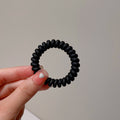 Black Matte Telephone Cord Spiral Coil Hair Tie With Thick Profile view 6