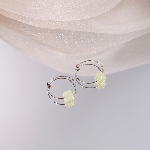 Silver double hoops with mint green beads on mirror