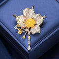 Flower Tassel Brooch in Metal with Layered Crystal Petals, Round Center, and Dangling Drop view 4