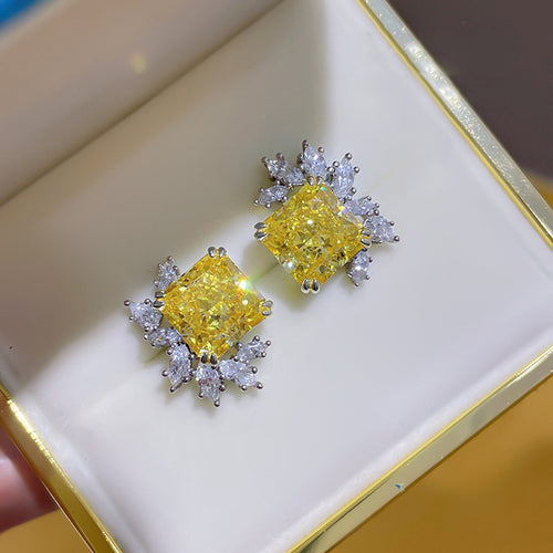 Yellow square studs in cream box gold rim top view