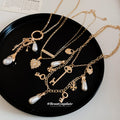 Gold Tone Layered Charm Necklaces With Decorative Accents view 2