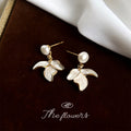 Gold Tone White Pearl Top And Three Petal Flower Drop Stud Earrings view 4