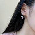 Pair of Metal Tone Pink Pearl Bow Stud Earrings with Clear Crystals view 4