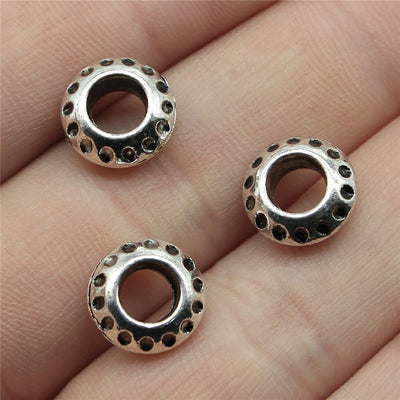 Two Finish Sunburst Large Hole Spacer Bead shown in hand