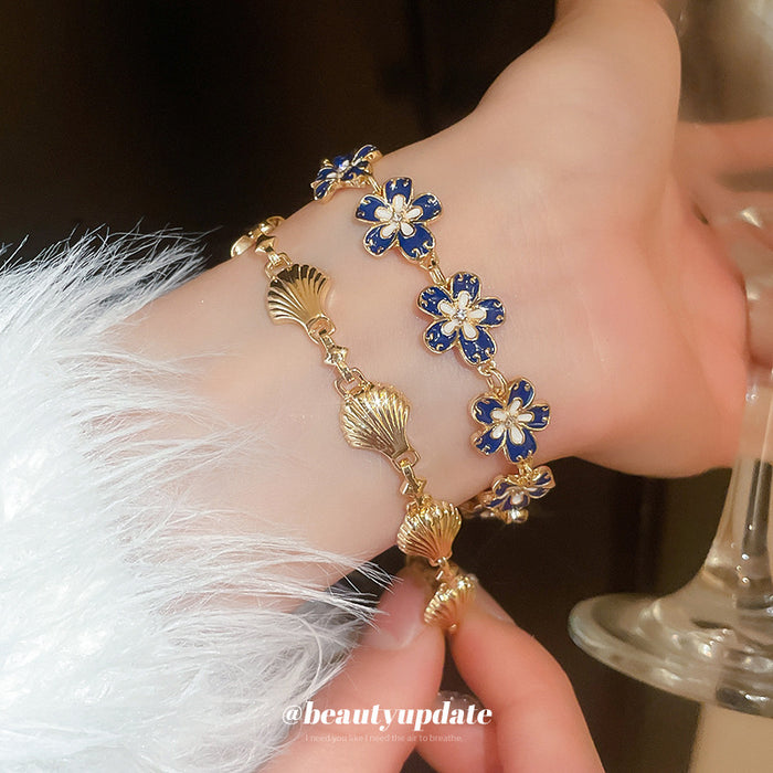 Gold Tone Blue Flower Bracelet And Unrelated Scallop Link Bracelet
