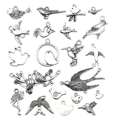 Antique silver seashell charms arranged on a light background