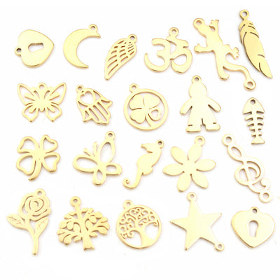 Overview of an assortment of thin gold-tone symbols including leaves, moons, flowers, insects, and trees