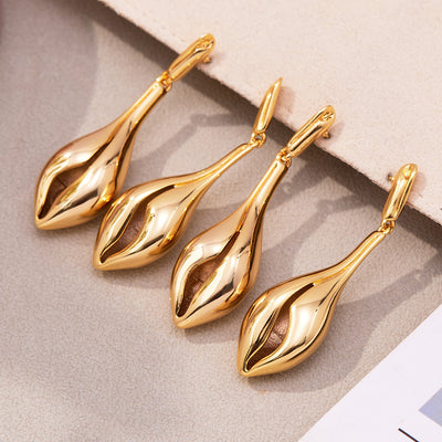 Display view of sculptural open shell drop earrings in main image 1.