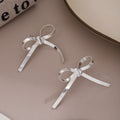 Silver Herringbone Ribbon Bow Stud Earrings Polished Metal view 1