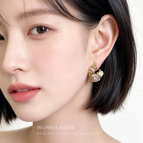 Pink heart liquid gold stud worn on model ear