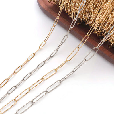 Metallic jewelry chain jewelry findings arranged on a light background