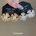 Pearl Center Radiating Flower Clip On Earrings With Polished Metal Details view 3