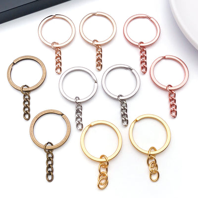 Metallic extender chain jewelry findings arranged on a light background