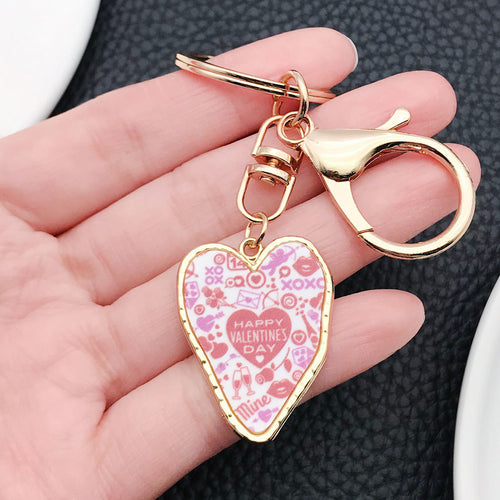 Styled close-up of xoxo wine glass and double heart valentine keychain showing colors and surface details