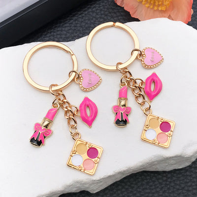 Overview showing the available color and design variations of the pink makeup compact lipstick and handbag metal keychai