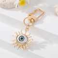 Gold Tone Sculpted Sun and Lash Realistic Eye Clip Keychains view 2