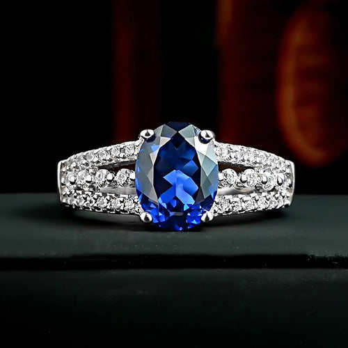 Additional product view showing silver-tone deep-blue oval solitaire triple-row wide ring