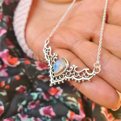 Front view of antler-shaped pendant around an opalescent center