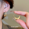 Gold Tone Sculpted Crescent Hook Earrings with Detailed Finish view 1