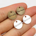Round Handmade Script Metal Charms in Silver and Bronze Tones view 1