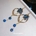 Blue Crystal Twisted Loop Dangle Hook Earrings with Polished Metal Details view 3
