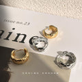 Faceted Sculptural Huggie Hoop Earrings In Gold And Silver Tone view 1