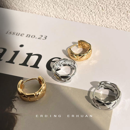 Faceted-sculptural huggies in gold and silver tone in the first product display.