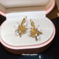 White Floral Hoop Earrings with Gold Tone Leaf Details view 2