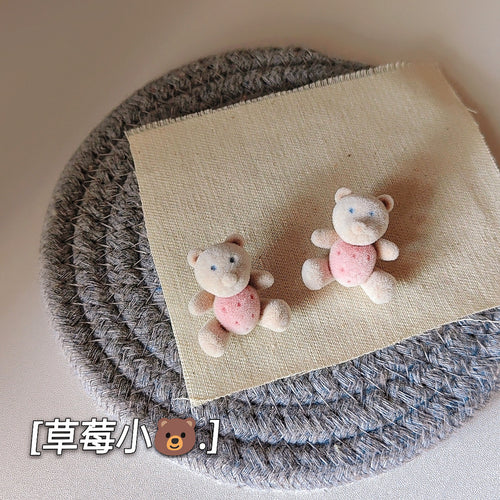 Flocked teddy bear studs on beige cloth over rope mat