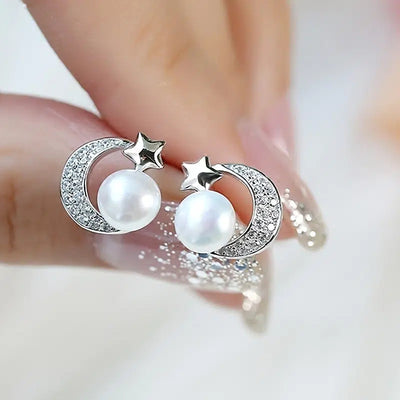 Front view of crescent moon and star studs with pearl-look centers