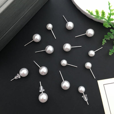 Black assorted shape charms arranged on a light background