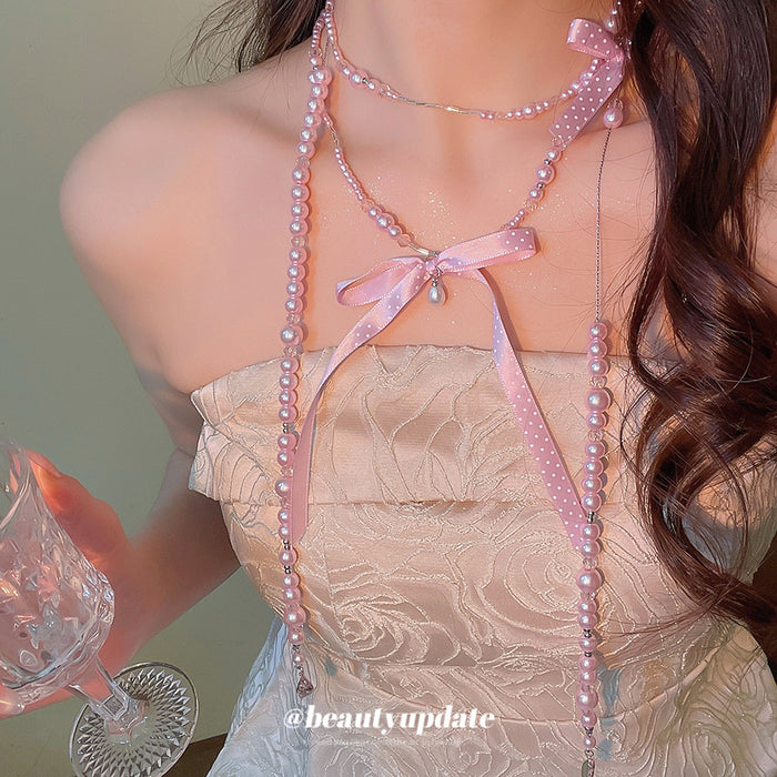 Long Pearl Strand Necklace With Crystal Bow Accents