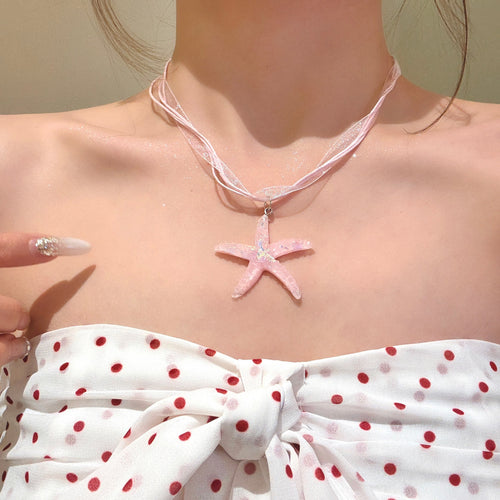 Styled view of cord necklaces with smooth starfish pendants in four colors