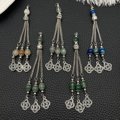 Black assorted shape charms arranged on a light background