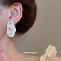 White Oval Floral Inlay Stud Earrings in Gold Tone view 3
