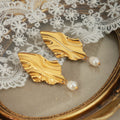 Gold Steel Wavy Leaf Drop Earrings With Pearl Dangles view 2