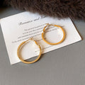 Metal Hoop Earrings in Gold and Silver with Varied Textures view 6