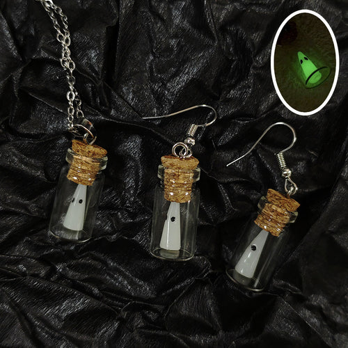 White ghost cork bottle necklace and matching earring pair on black fabric