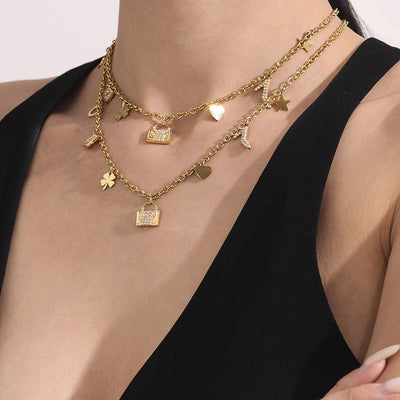 Coordinated set view of mixed charm necklace and bracelet in main image 1.