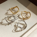 Irregular Wavy Hoop Earrings In Gold And Silver Tones view 1