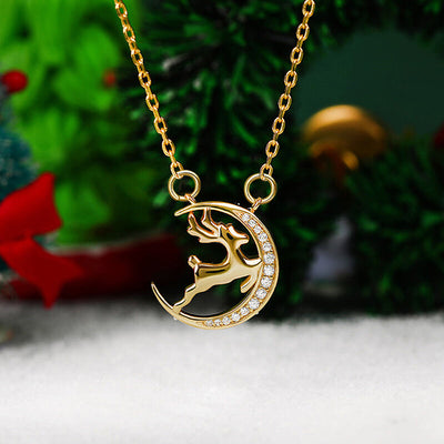 Front product view of gold tone reindeer crescent moon pendant necklace with stones