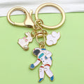 Gold-Tone Space Metal Keychains with Astronaut and Rocket Charms view 1