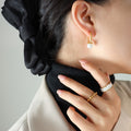 Gold Oval Huggie Hoop Earrings White Glass Pearl Drop view 4