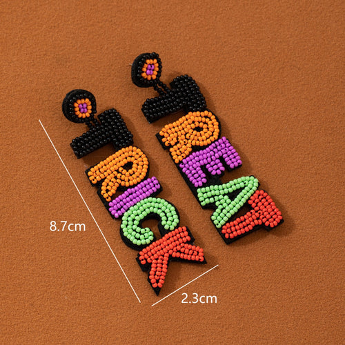 Both Trick Or Treat beaded earrings laid flat showing 8.7cm length and 2.3cm width measurements