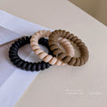 Black Matte Telephone Cord Spiral Coil Hair Tie With Thick Profile view 3