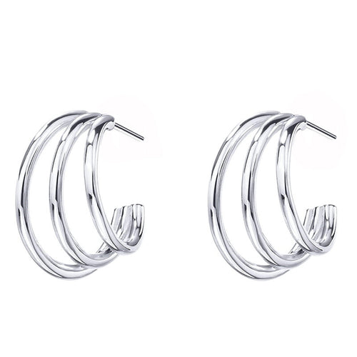 Angled detail view of gold tone triple wire hoop earrings with layered open design